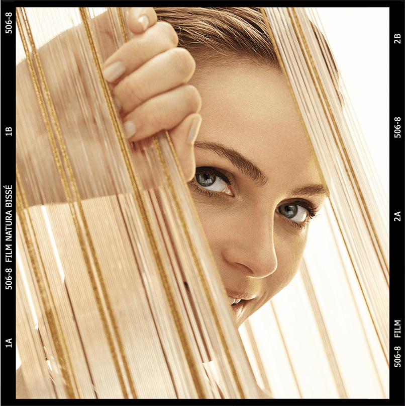 Girl showing her face behind a curtain