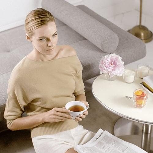 Girl drinking tea with Inhibit HD correcting patches applied